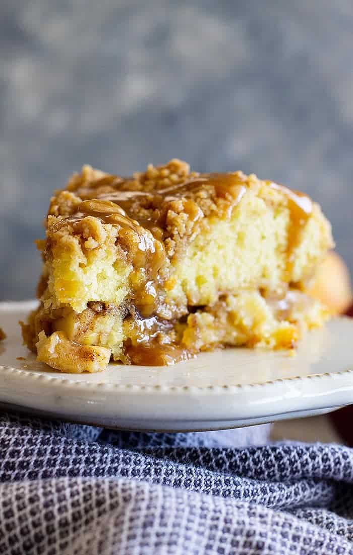 This Apple Crumb Cake is the perfect fall treat! It's filled with spiced apples, an extra thick crumb layer, and a tender cake. Drizzle with an easy homemade caramel sauce for the perfect treat!
