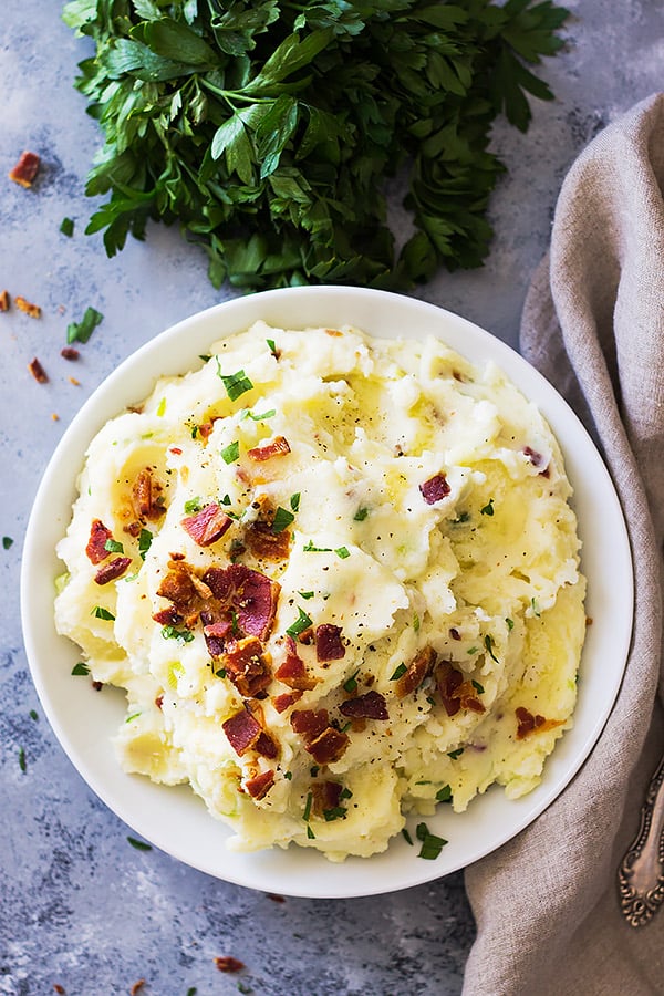 Bacon Mashed Potatoes are creamy, fluffy and full of flavor! Studded with crispy bacon, green onions and made ultra decadent with a little cream cheese. | www.countrysidecravings.com