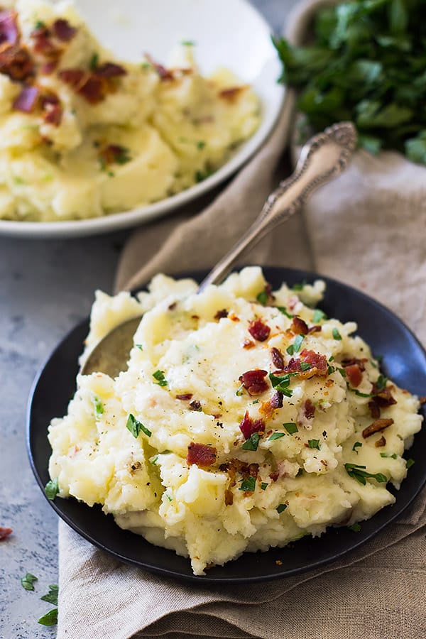 Bacon Mashed Potatoes are creamy, fluffy and full of flavor! Studded with crispy bacon, green onions and made ultra decadent with a little cream cheese. | www.countrysidecravings.com