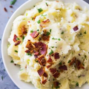 Bacon Mashed Potatoes are creamy, fluffy and full of flavor! Studded with crispy bacon, green onions and made ultra decadent with a little cream cheese. | www.countrysidecravings.com