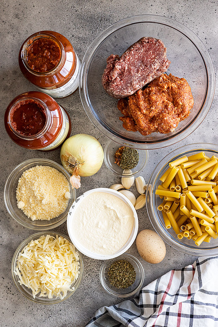 Ingredients for this pasta dish: ground beef, Italian sausage, ricotta, mozzarella, herbs, pasta sauce.