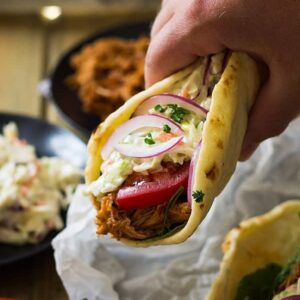 hand holding bbq pulled pork gyro