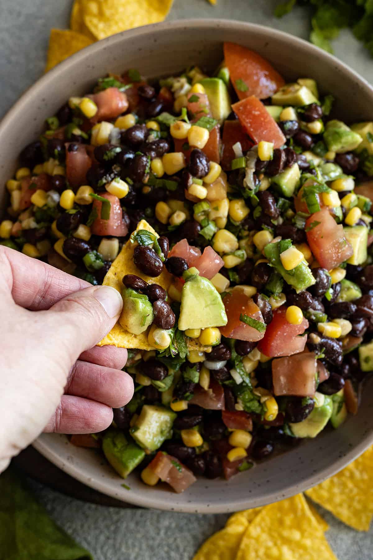 Chip being dipped into the salsa. 