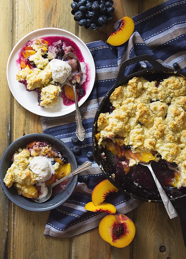 Blueberry Peach Cobbler -an easy recipe made with fresh peaches and blueberries baked beneath a fluffy biscuit topping! | www.countrysidecravings.com