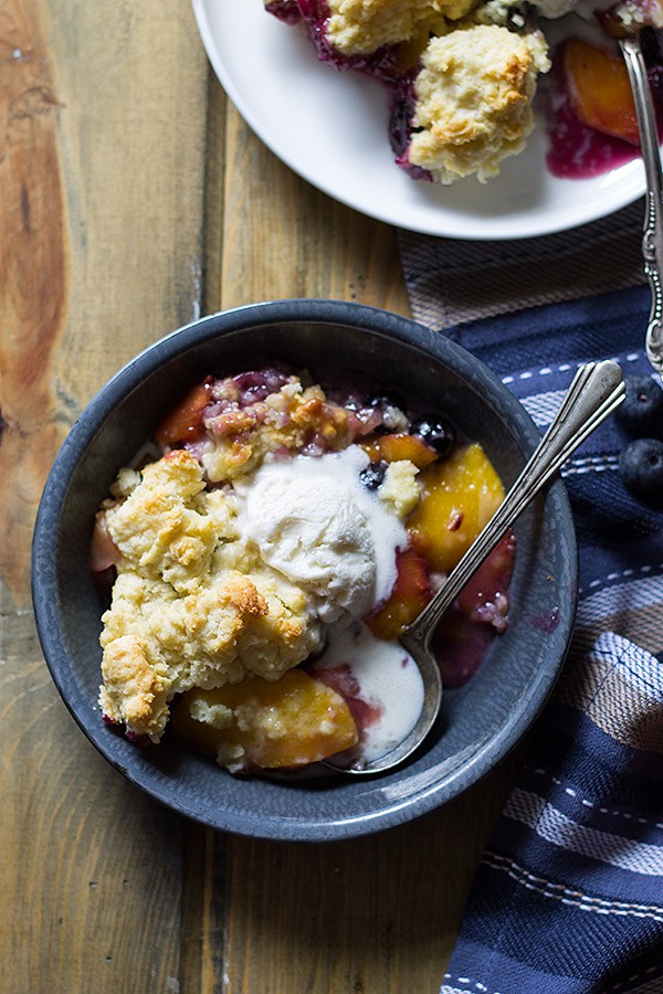 Blueberry Peach Cobbler -an easy recipe made with fresh peaches and blueberries baked beneath a fluffy biscuit topping! | www.countrysidecravings.com