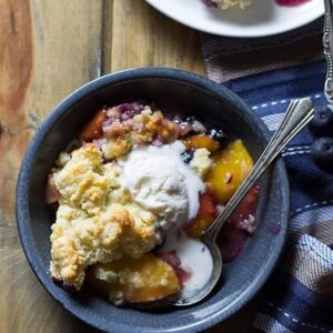 Blueberry Peach Cobbler -an easy recipe made with fresh peaches and blueberries baked beneath a fluffy biscuit topping! | www.countrysidecravings.com