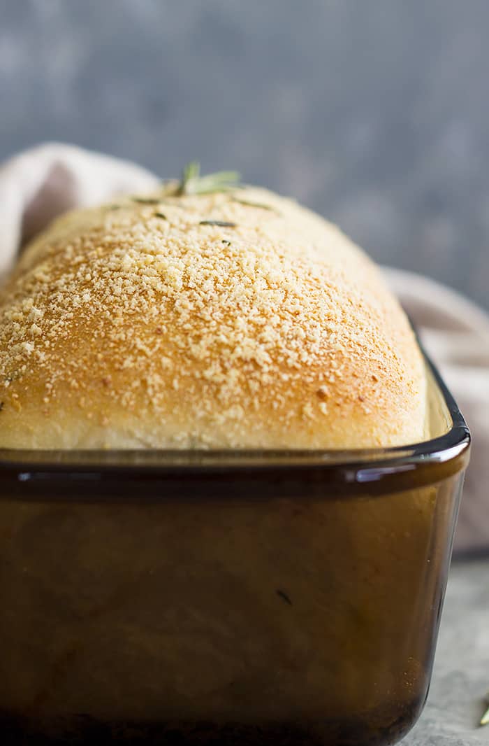 side view of bread in a pan with parmesan cheese