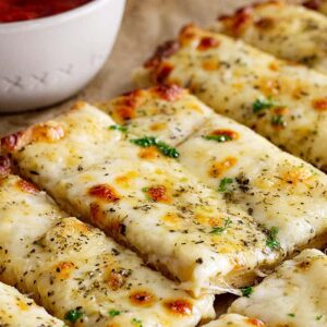 Close up of cheese breadsticks.