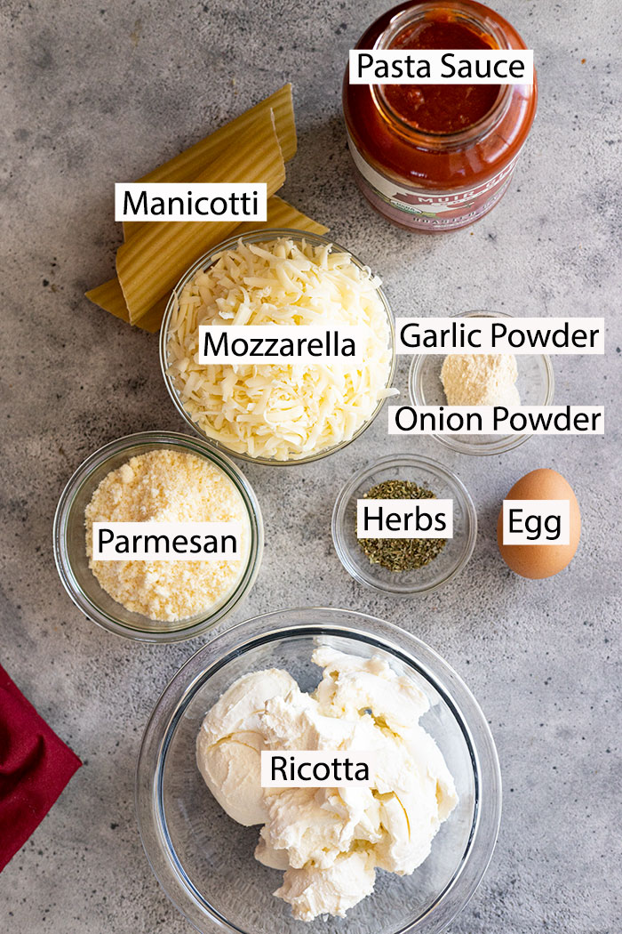 Ingredients for cheese manicotti: ricotta, parmesan, mozzarella, herbs, egg, manicotti, pasta sauce.