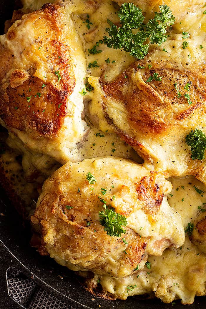 Close up of chicken and stuffing casserole in the pan garnished with parsley. 