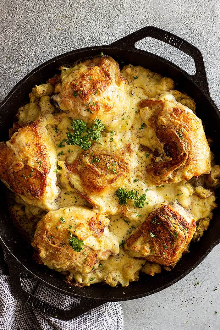Overhead view of casserole in a cast iron pan fresh from the oven. Garnished with parsley.