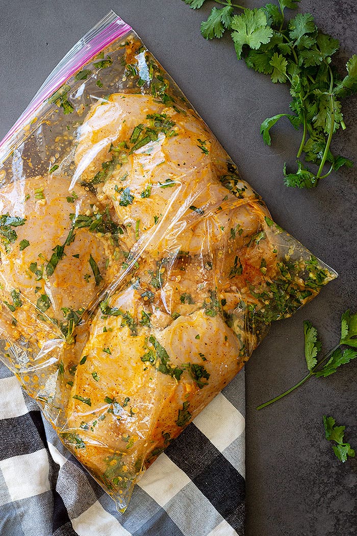 Chicken marinating in a bag.