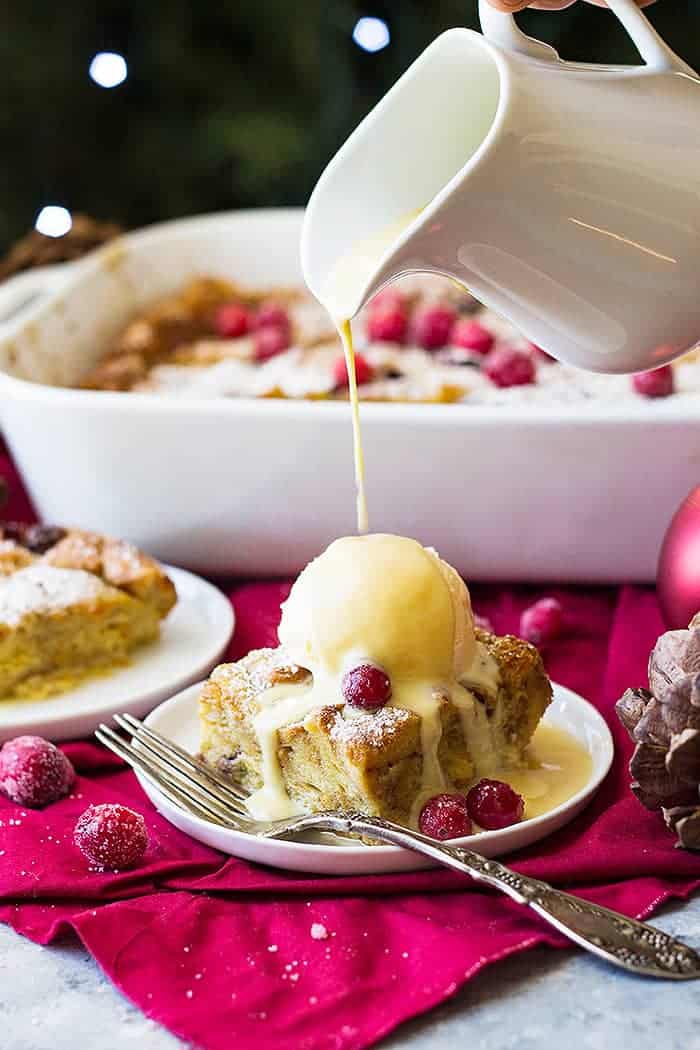 This Cranberry Bread Pudding with Whiskey Cream Sauce is an indulgent dessert! Brioche bread baked in a cinnamon custard then topped with a whiskey cream sauce!