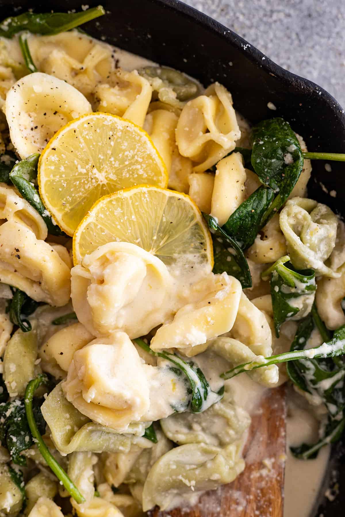 Close up of pasta dish. Garnished with lemon slices. 