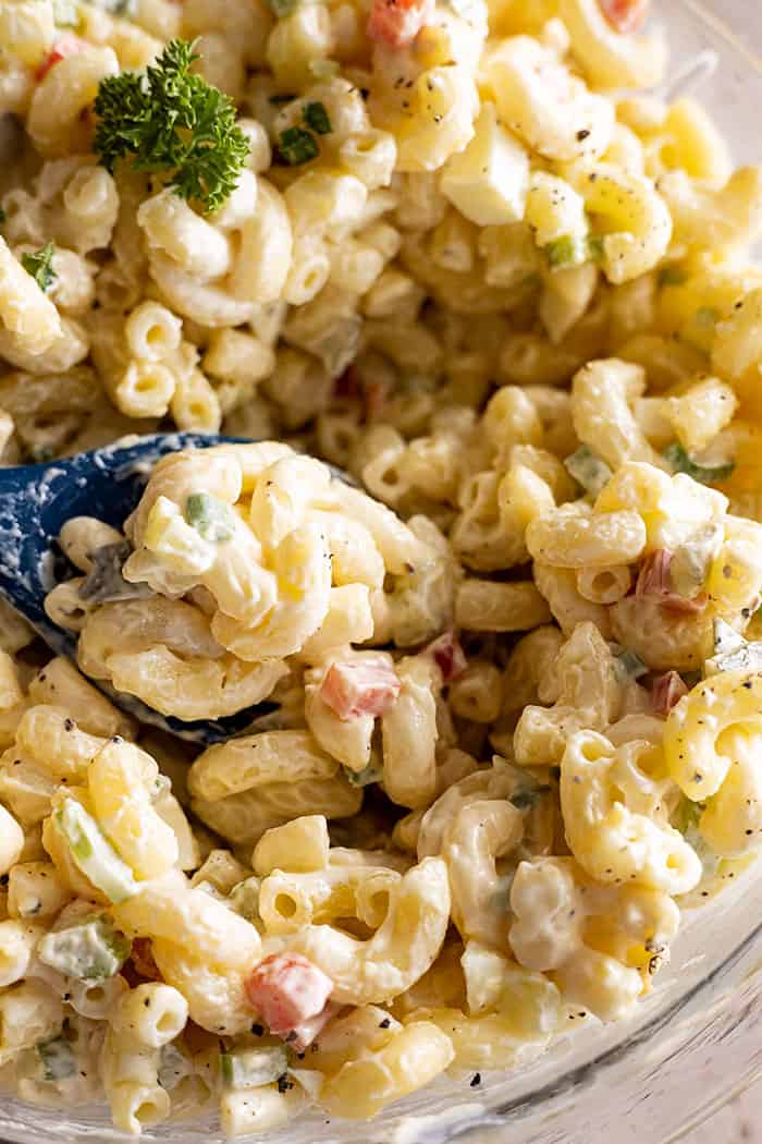 closeup: my creamy macaroni salad recipe in a bowl with a spoon
