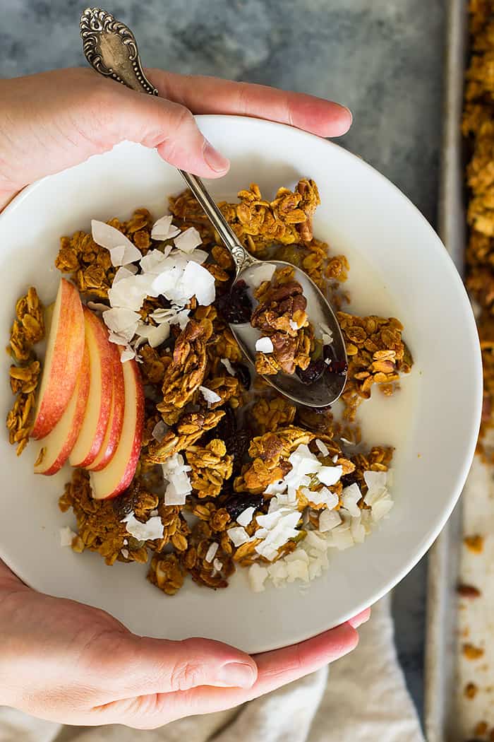 This Crunchy Pumpkin Granola is filled with warming fall goodness! It's make with real pumpkin, nuts, dried fruit and naturally sweetened. 
