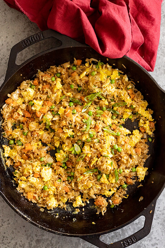 Overhead of rice freshly made in a skillet. Red napkin off to the side.
