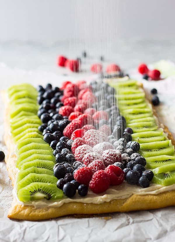 This Easy Fruit Pizza is a quick and simple recipe. It features crescent dough, sweetened cream cheese and lots of juicy fruit!