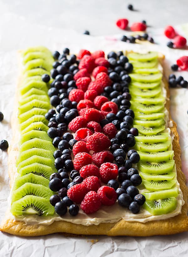 This Easy Fruit Pizza is an easy recipe thanks to store bought crescent dough. It's then topped with sweetened cream cheese and loads of juicy fruit!