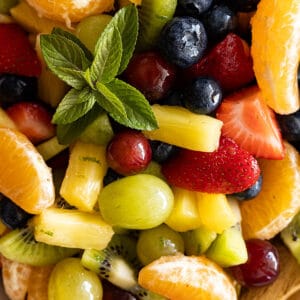 Close up of easy fruit salad. Fresh mint to garnish.