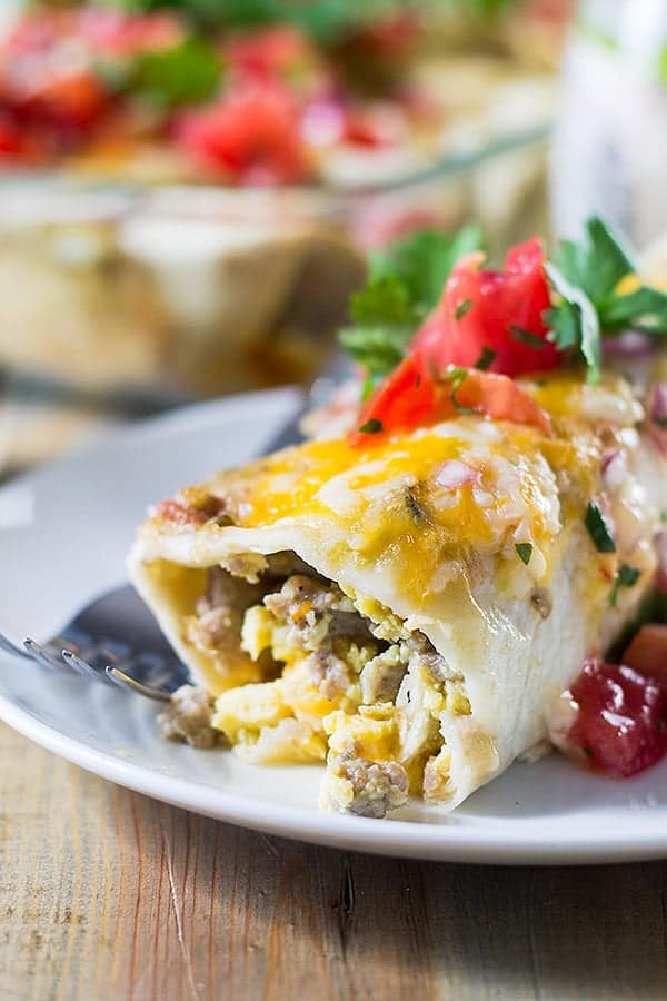 side view closeup: egg enchiladas full of sausage and scrambled eggs