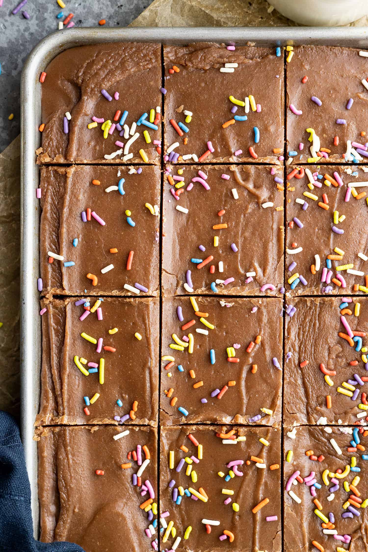 Overhead view of frosted brownies cut in the pan. 