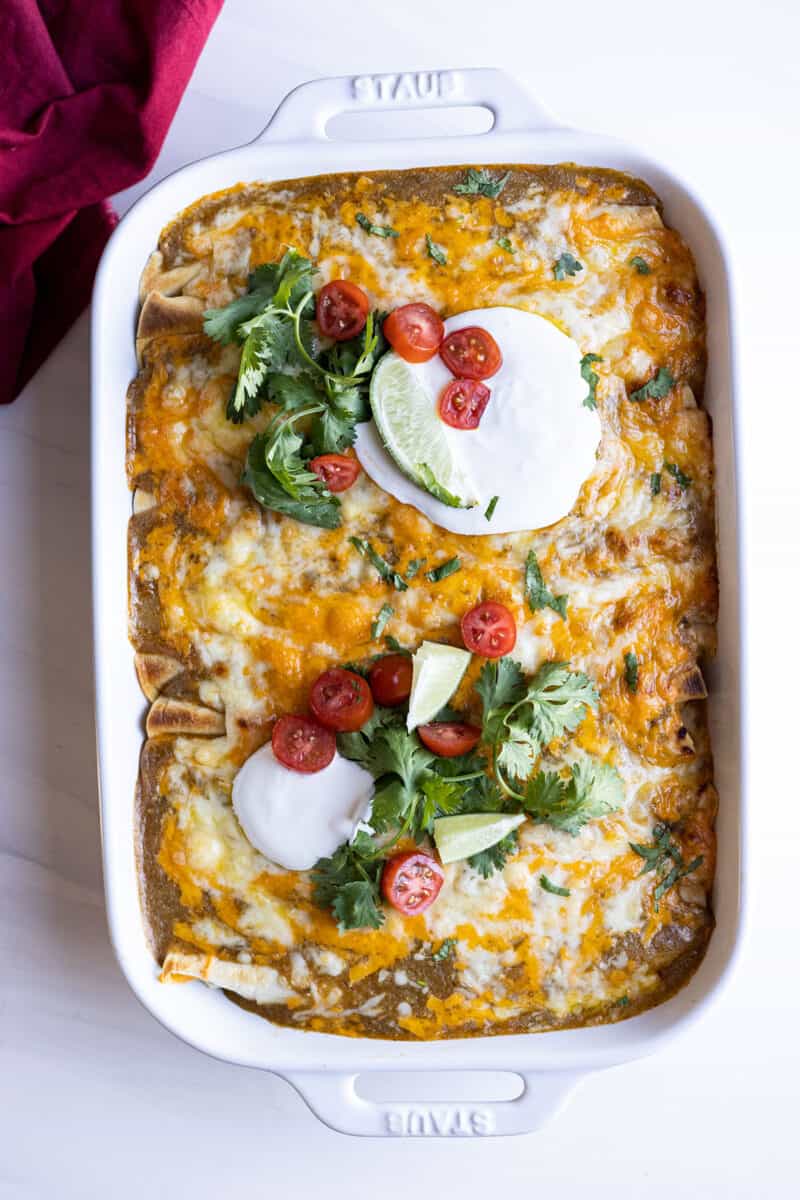 Overhead view of finished green chile chicken enchiladas fresh from the oven.