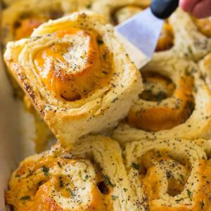 These Ham and Cheddar Biscuit Rolls are made with homemade biscuit dough, ham, cheddar and topped with a yummy glaze! | www.countrysidecravings.com