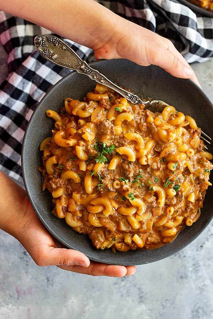 holding a plate with homemade hamburger helper