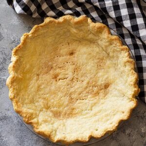 Top down view of a golden blind baked pie crust.