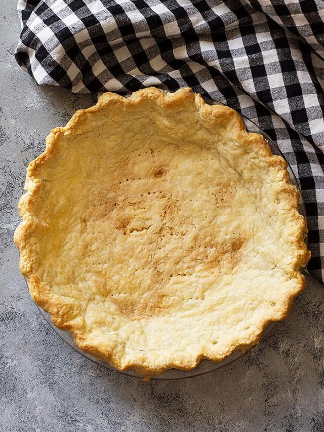 Top down view of a golden blind baked pie crust.