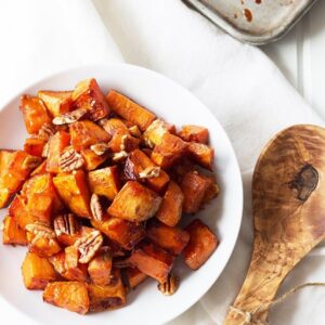 Maple Roasted Sweet Potatoes- these are lightly sweetened with maple syrup, spiced with cinnamon and have an optional crunch from pecans, YUM! | countrysidecravings.com