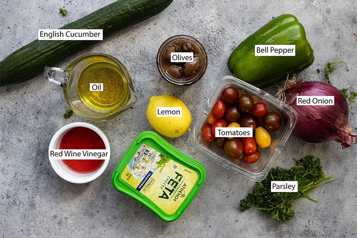 Ingredients: cucumber, olives, bell pepper, onion, tomatoes, parsley, lemon, feta, red wine vinegar, oil.