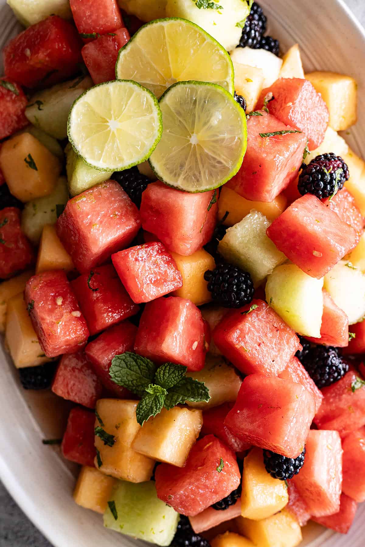 Overhead view of salad on a cream serving platter. 