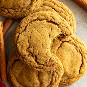 Overhead view of molasses cookies. One with a bite taken out.