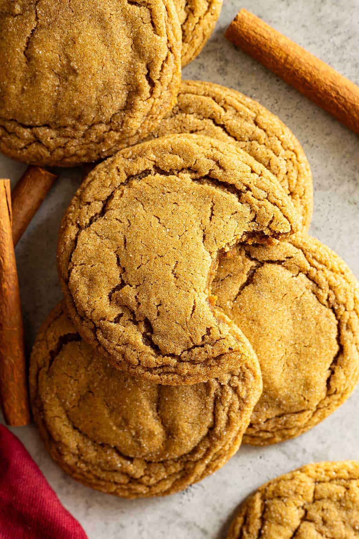 Overhead view of molasses cookies. One with a bite taken out. 