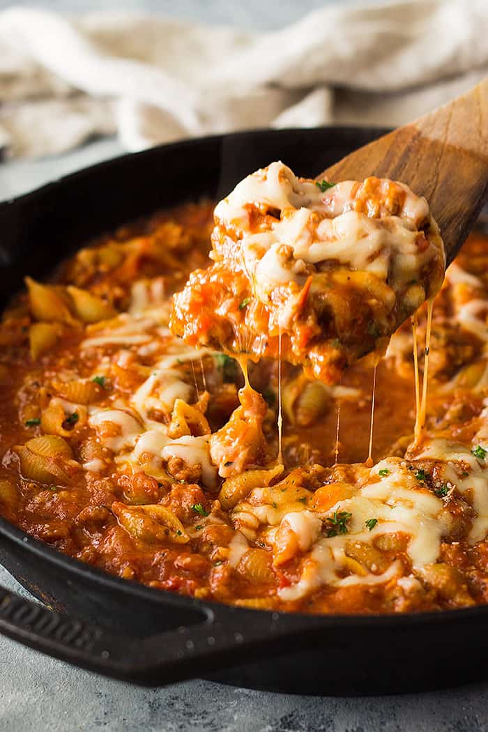 wooden spoon holding one pot sausage pasta