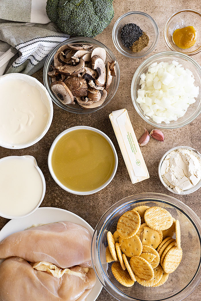 Ingredients for the casserole: chicken, chicken broth, sour cream, crackers, mushrooms, broccoli. onion, and poppy seeds.
