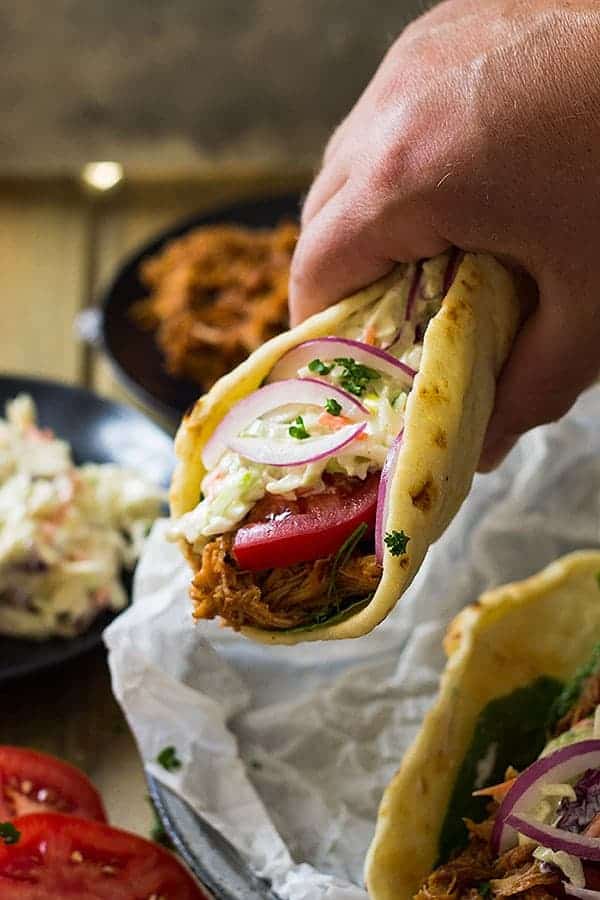 closeup: hand holding a bbq pulled pork gyro