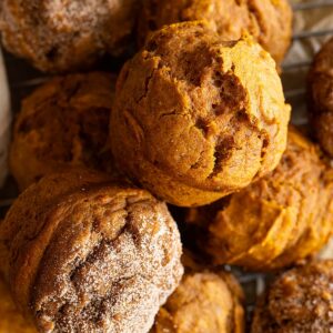 Overhead view of several pumpkin muffins piled together.