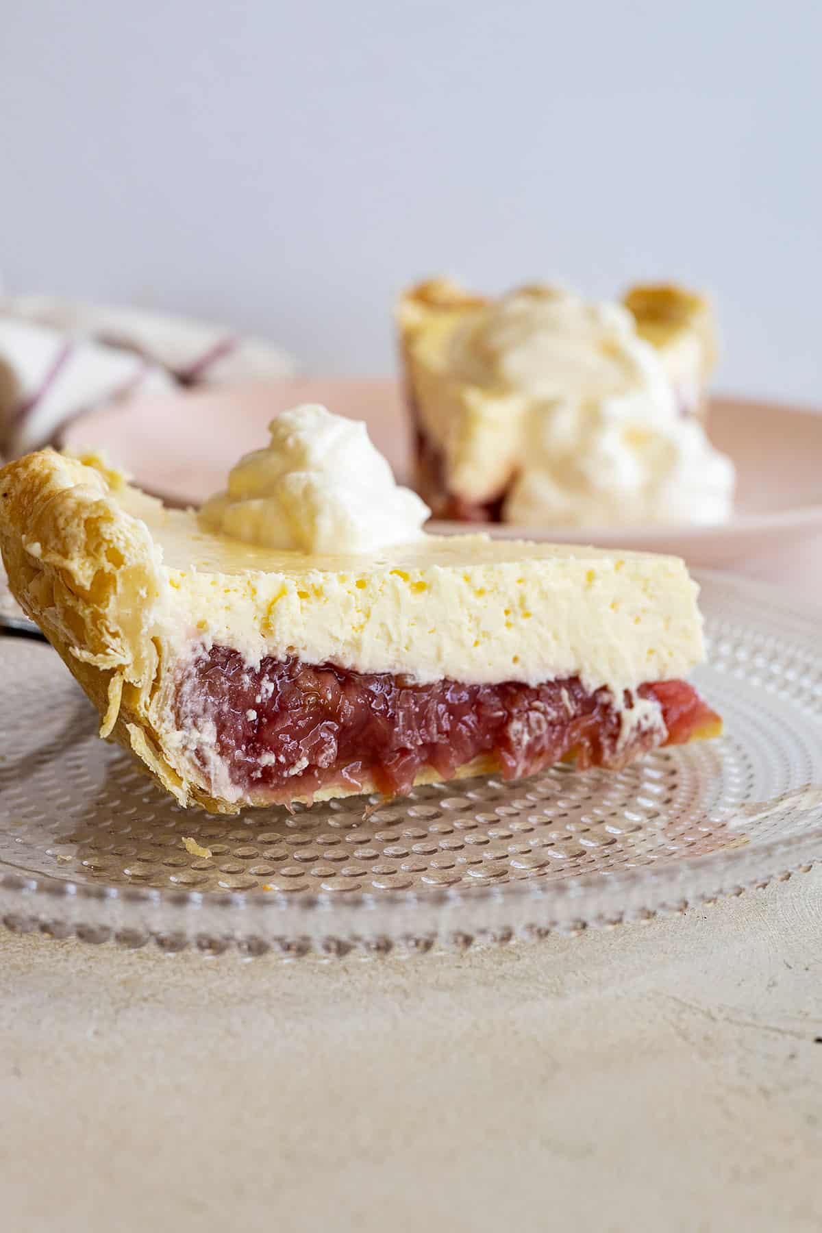 Side view of rhubarb cheesecake pie showing the lovely layers. 
