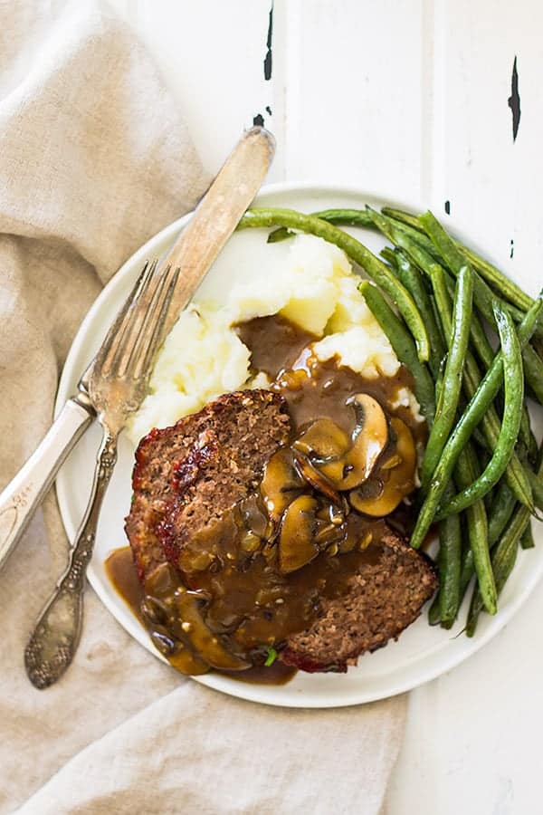 overhead shot of plate with green beans and meatloaf