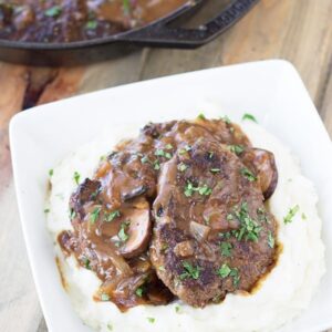 Salisbury Steak with Mushrooms and Creamy Mashed Potaotes- This is classic comfort food, but I promise it tastes way better than frozen or what you may remember from your school cafeteria! Serve it with the creamy mashed potatoes and you have a wonderfully satisfying meal! | Countryside Cravings