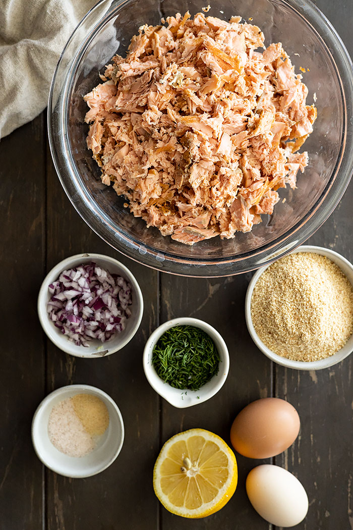 Overhead of all the ingredients needed to make salmon burgers.