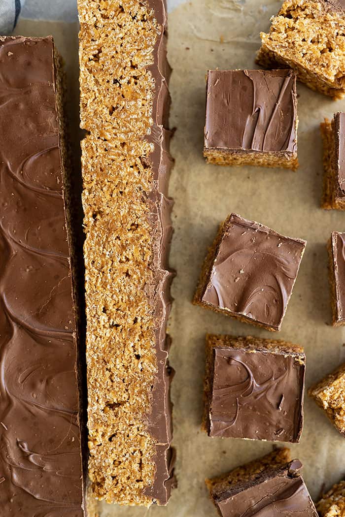 Overhead view of scotcharoo bars being cut into bars. 