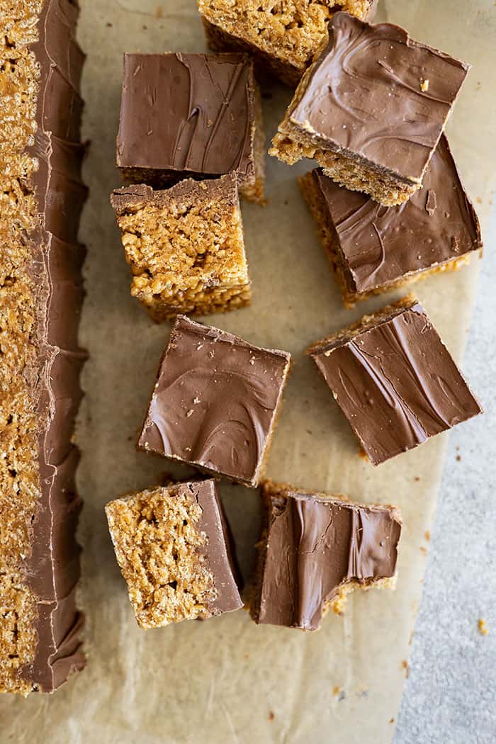 Several scotcheroo recipe bars scattered with some on their sides and some stacked on top of each other