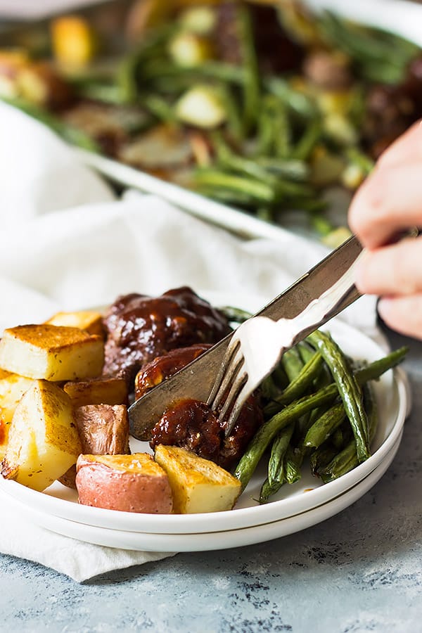 sheet pan bbq meatballs and roasted veggies on a plate