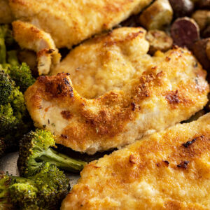 Close up of the chicken on the sheet pan fresh from the oven. Shows the browning on the chicken.