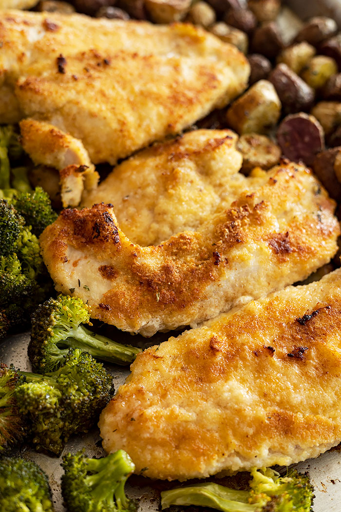 Close up of the chicken on the sheet pan fresh from the oven. Shows the browning on the chicken.