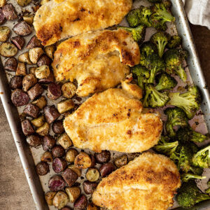 Overhead view of sheet pan dinner fresh from the oven. Tan towel in the corner.